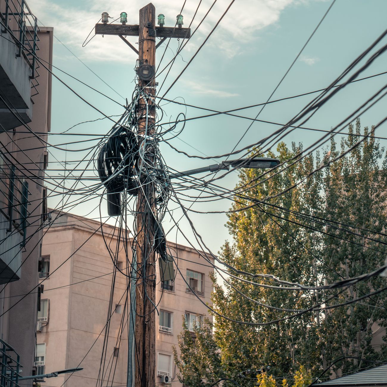 city pole with electric wires messy connections